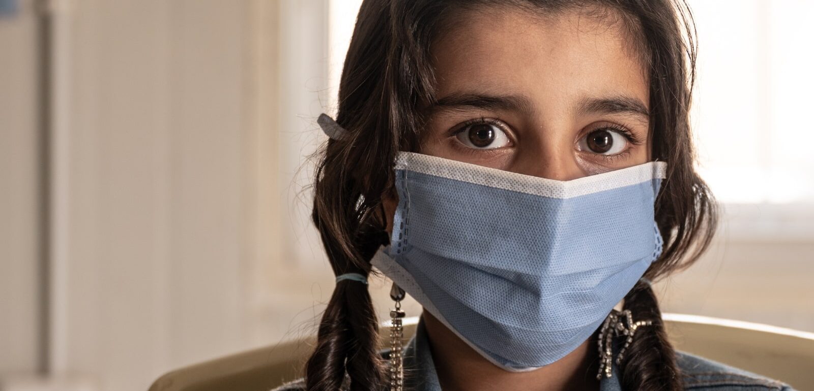 Syrian refugee wearing a face mask during the COVID-19 pandemic, from 'Stressed: A Pandemic of Fear' documentary.